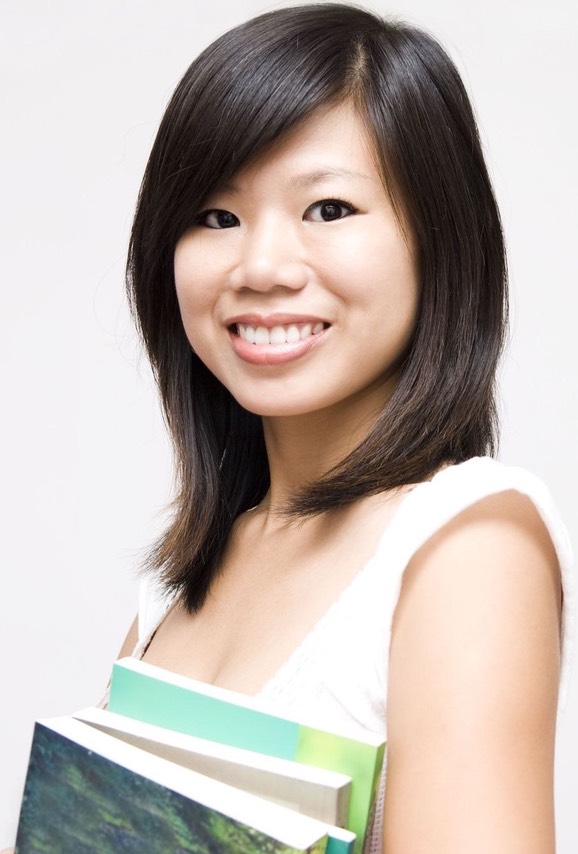 Asian female student holding book CROPPED