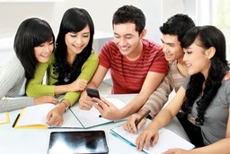Asian students at table w calculator